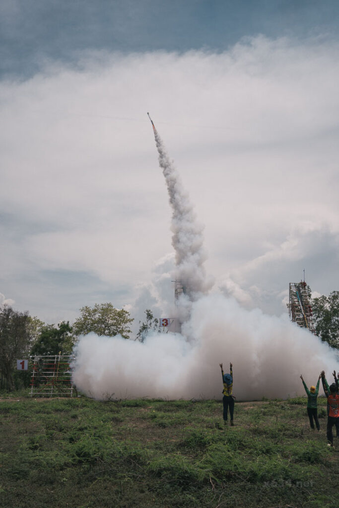 轟音とともに白い煙の尾を引き、天界の神へ向かって高く打ち上がる巨大ロケット