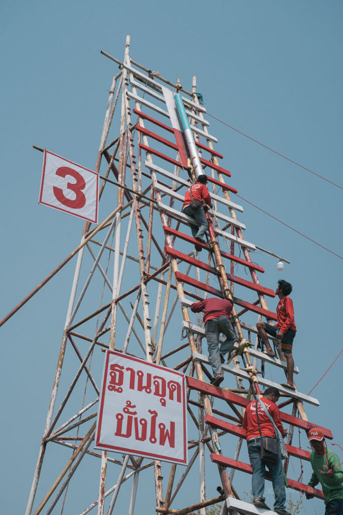 ブン・バンファイの巨大な発射台に登り、ロケットの角度を慎重に調整するチームのメンバー